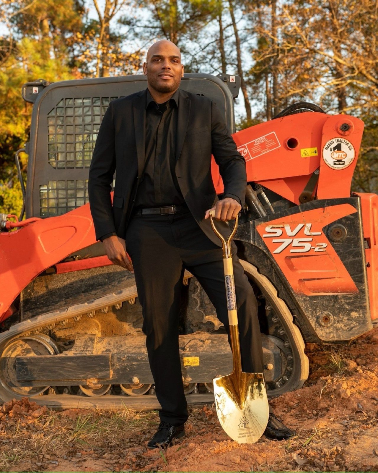 Rashad holding the gold groundbreaking shovel at the Valentina Estates groundbreaking