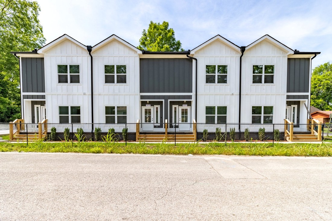 The finished Kali Townhomes at 1622 Bradt St: four white and charcoal townhomes